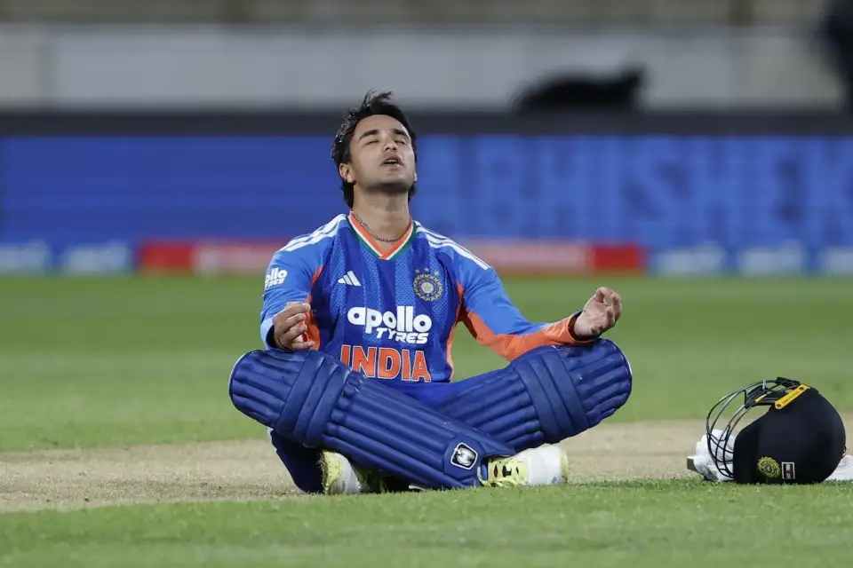 Abhishek Sharma sitting on the cricket pitch in meditation celebration pose during India vs New Zealand match